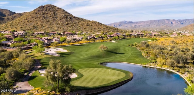 surrounding community with view of golf course and a water and mountain view