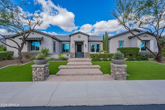 mediterranean / spanish-style house featuring a front yard