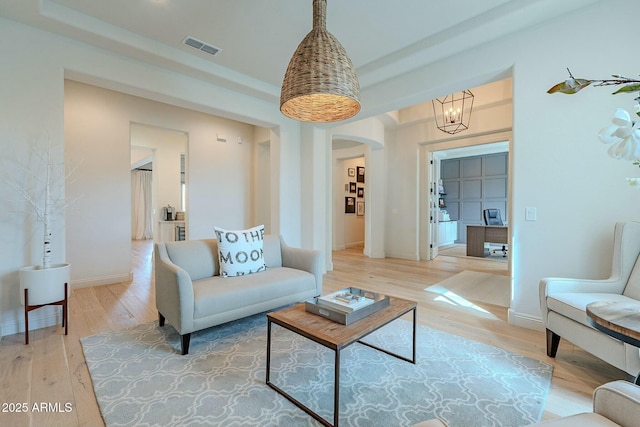 living room featuring hardwood / wood-style flooring and a notable chandelier