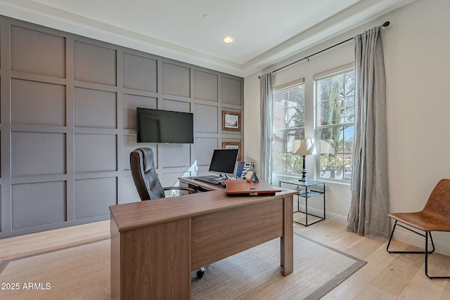 office space featuring light hardwood / wood-style flooring and a healthy amount of sunlight