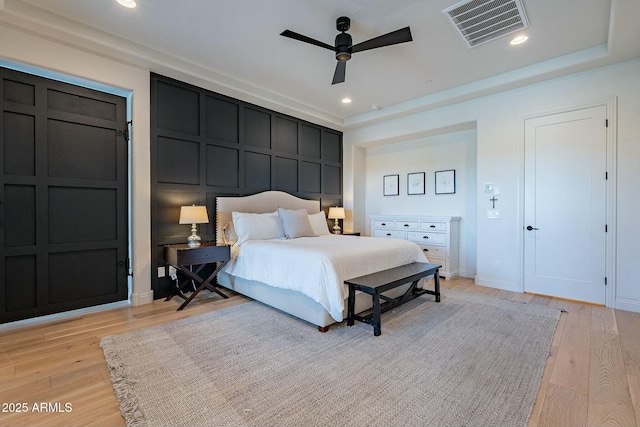 bedroom with light hardwood / wood-style flooring and ceiling fan