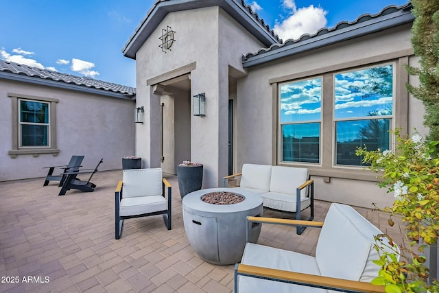 view of patio featuring an outdoor living space with a fire pit