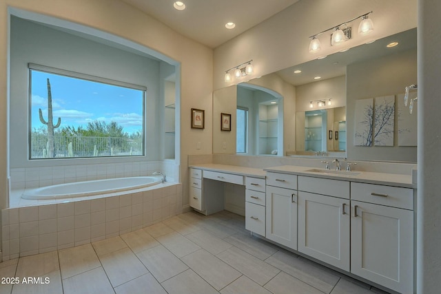 bathroom featuring tiled bath, tile patterned flooring, vanity, and built in features