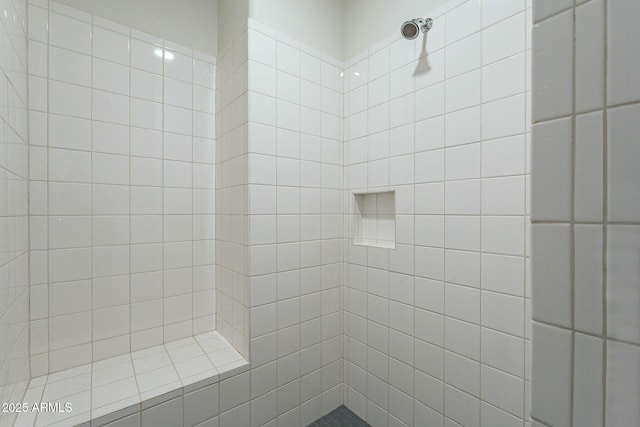 bathroom with a tile shower