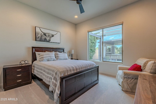 bedroom featuring ceiling fan and light carpet