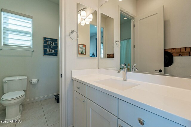 bathroom featuring tile patterned flooring, vanity, and toilet