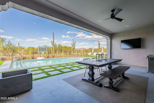 view of patio featuring a fenced in pool and ceiling fan