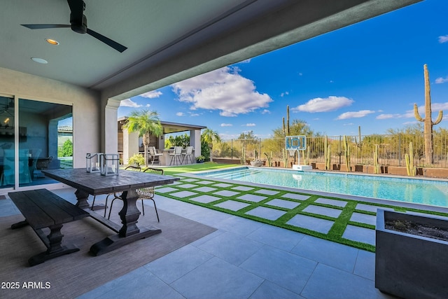 view of pool with ceiling fan, an outdoor bar, and a patio