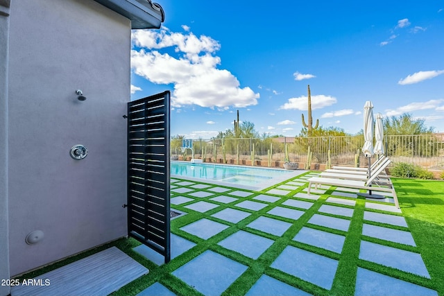 view of yard with a fenced in pool