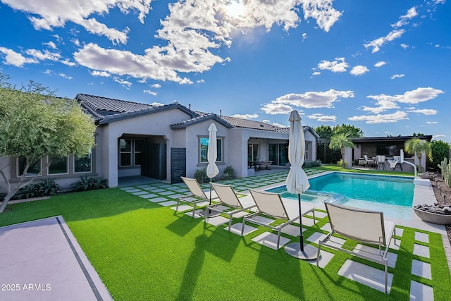 rear view of property with a patio area and a yard