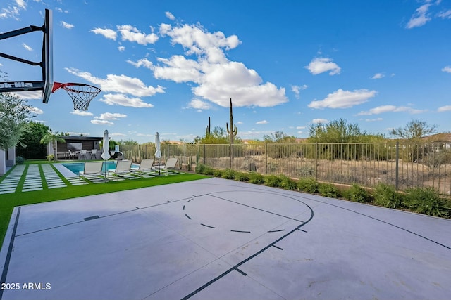 view of basketball court featuring a lawn