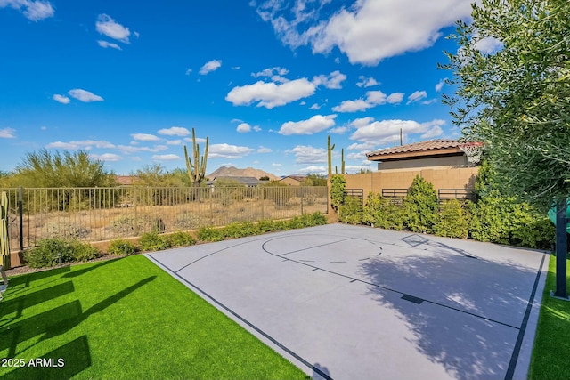 view of basketball court featuring a lawn