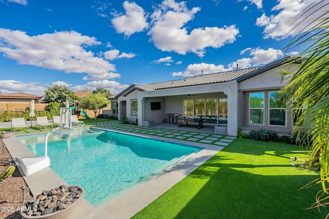 view of swimming pool featuring a playground, a patio area, and a yard