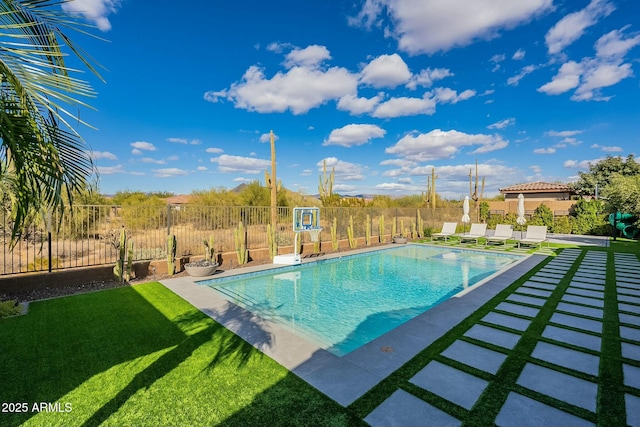 view of swimming pool with a patio area and a yard