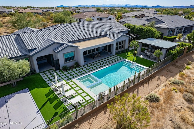 exterior space featuring a mountain view, a patio area, and a bar