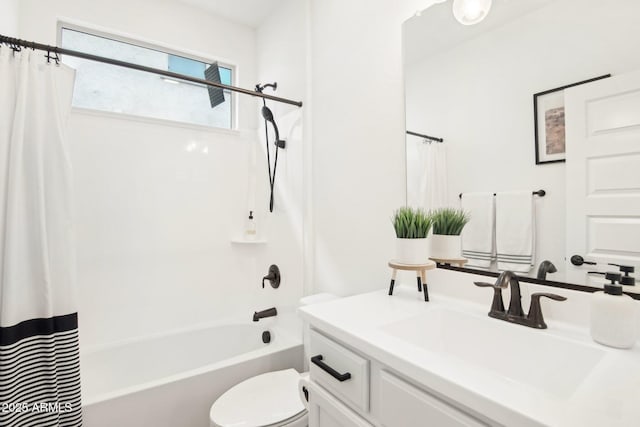 full bathroom featuring shower / bath combo, vanity, and toilet