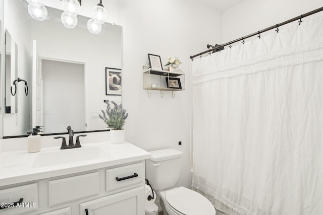 bathroom featuring vanity and toilet