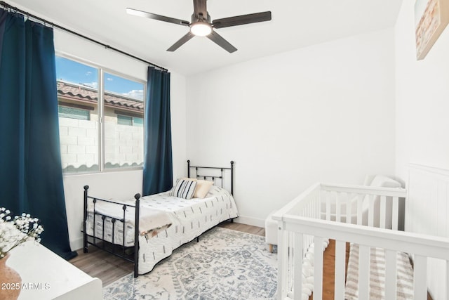 bedroom featuring hardwood / wood-style floors and ceiling fan