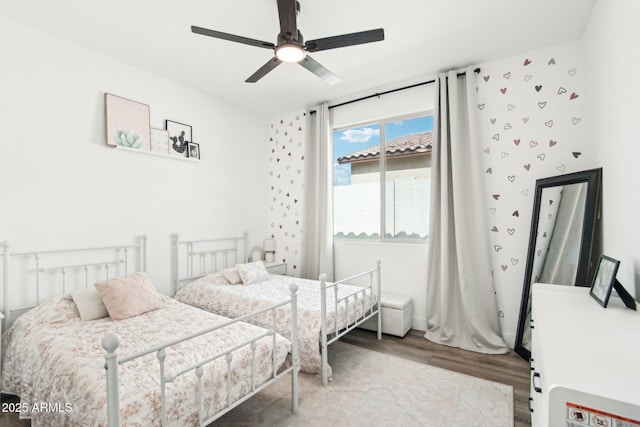 bedroom featuring wood-type flooring and ceiling fan