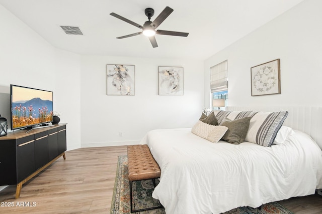 bedroom with ceiling fan and hardwood / wood-style floors