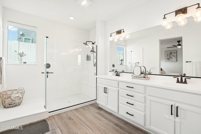 bathroom with an enclosed shower, vanity, hardwood / wood-style flooring, and ceiling fan