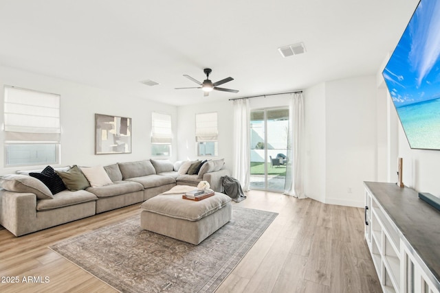 living room featuring ceiling fan and light wood-type flooring