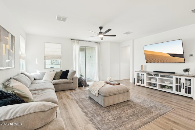 living room featuring hardwood / wood-style flooring and ceiling fan