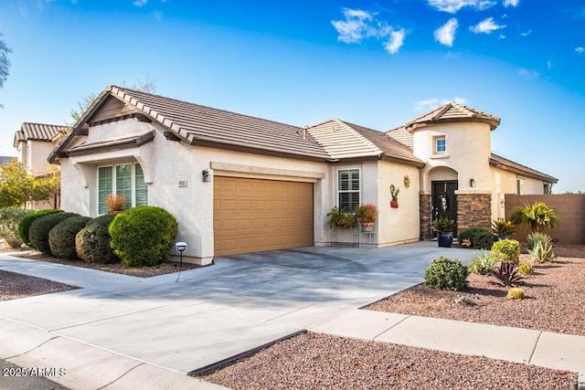 view of front of house with stucco siding, fence, a garage, stone siding, and driveway