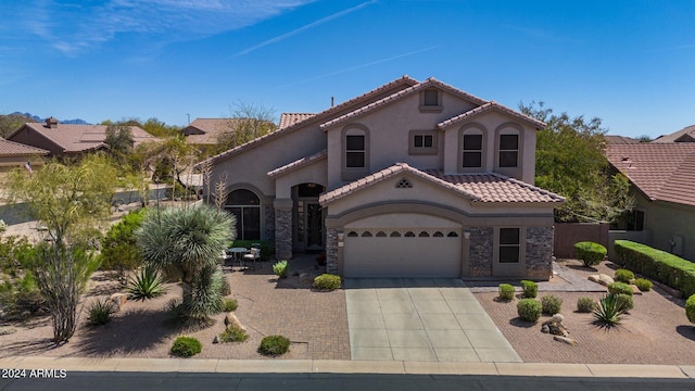 mediterranean / spanish-style house with a garage