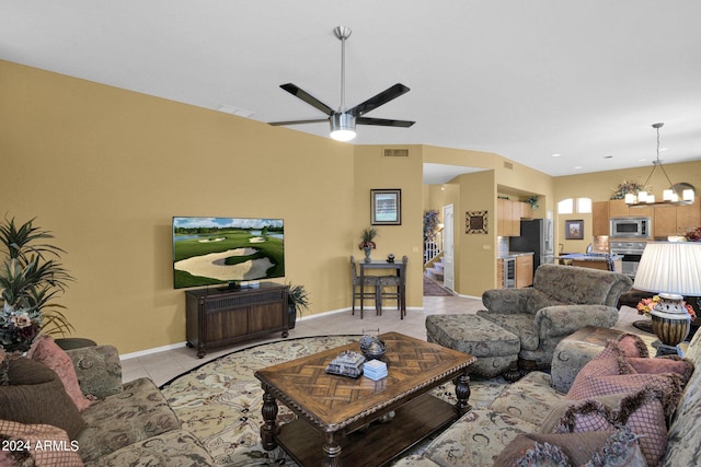 tiled living room featuring ceiling fan with notable chandelier