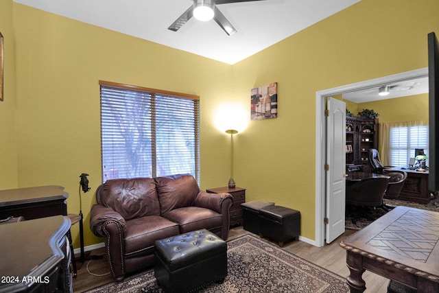 living room featuring ceiling fan and light hardwood / wood-style flooring