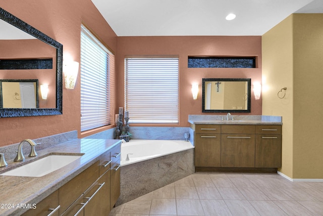 bathroom featuring vanity, a relaxing tiled tub, and tile patterned flooring