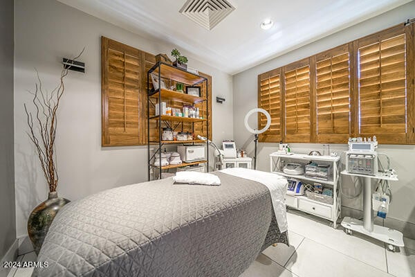 bedroom with light tile patterned floors