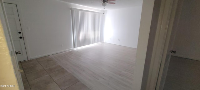 spare room featuring light hardwood / wood-style flooring and ceiling fan