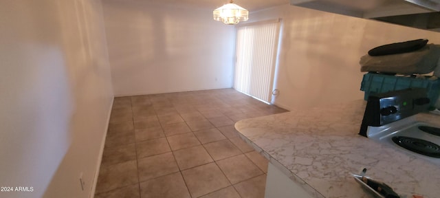 kitchen featuring light tile patterned floors, pendant lighting, and a notable chandelier