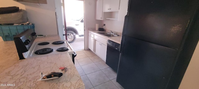 kitchen with black appliances, white cabinetry, light tile patterned floors, and sink