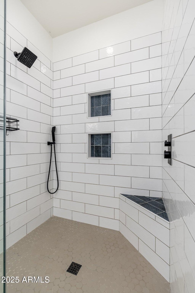 bathroom with a tile shower