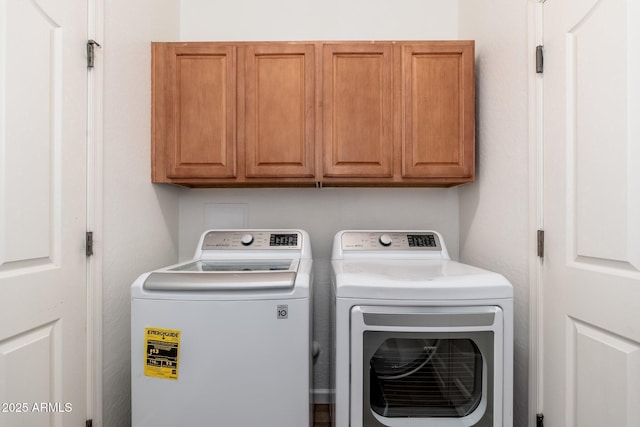 washroom with independent washer and dryer and cabinet space