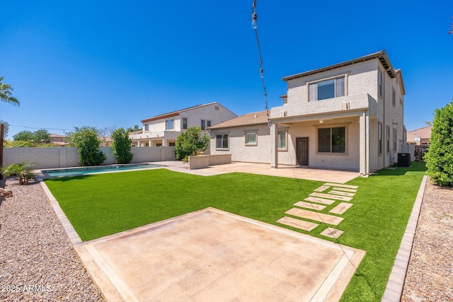 back of house with a yard, a fenced backyard, a patio, stucco siding, and a fenced in pool