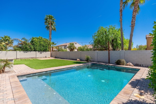 view of pool with a yard, a fenced backyard, a fenced in pool, and a patio