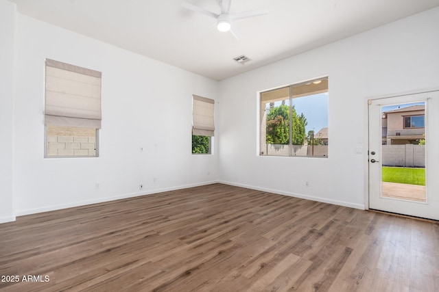 unfurnished room with visible vents, baseboards, a ceiling fan, and wood finished floors