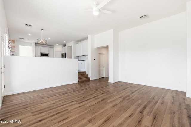 unfurnished living room featuring light wood-style floors, ceiling fan, and visible vents