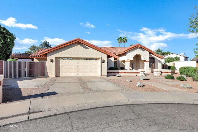322 E Gary Cir, Mesa, AZ 85201 - mediterranean / spanish-style house with a tile roof, stucco siding, a garage, and driveway