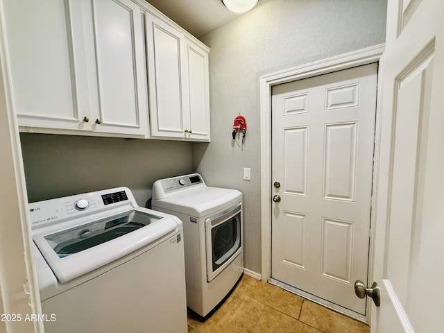 719 S 2nd St, Avondale, AZ 85323 - washroom with washer and clothes dryer, cabinet space, light tile patterned floors, and a textured wall