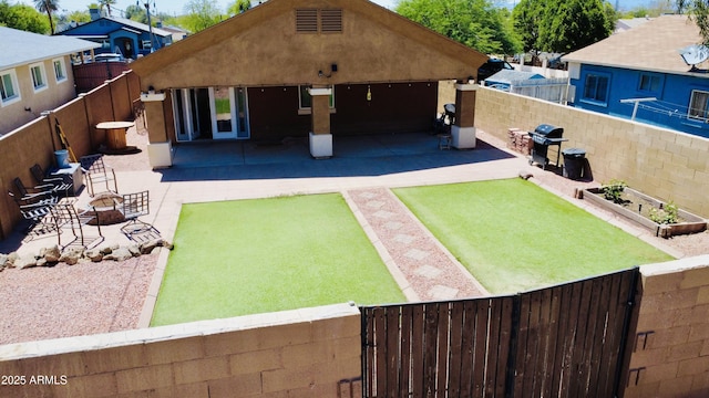 719 S 2nd St, Avondale, AZ 85323 - back of property with a fenced backyard, a patio area, and stucco siding
