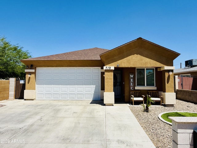 719 S 2nd St, Avondale, AZ 85323 - ranch-style house featuring stucco siding, driveway, a garage, and cooling unit