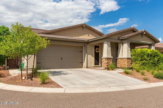 view of front facade with stucco siding, a garage, stone siding, driveway, and a tiled roof