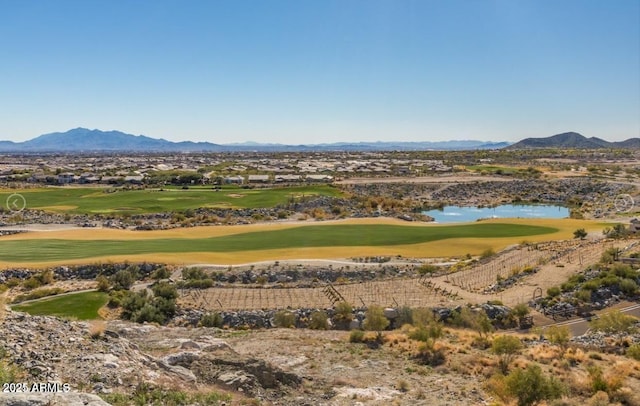 view of mountain feature featuring view of golf course and a water view