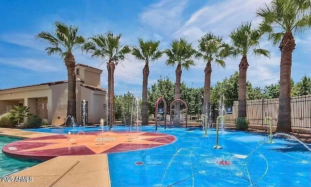 view of basketball court featuring fence