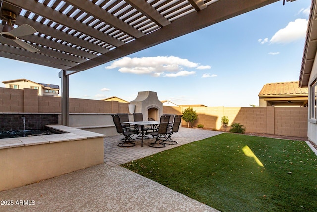 view of yard with a patio area, a fenced backyard, and a fireplace